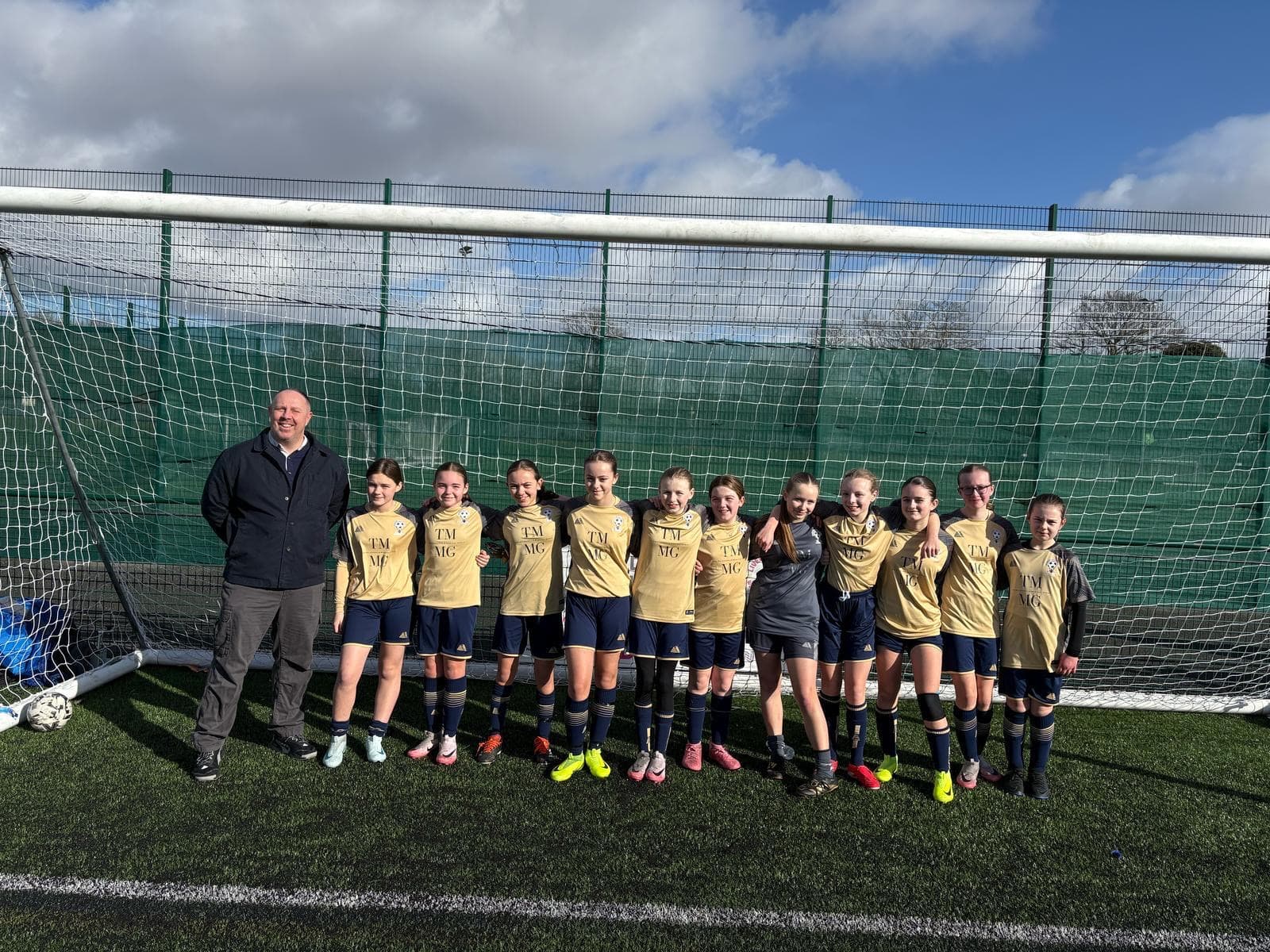 Grassroots girls football team sponsored by The McLoughlin Medical Group